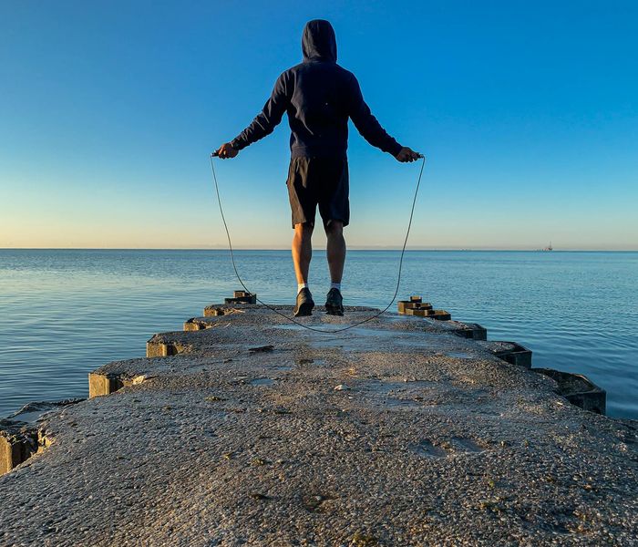 Silhouette of a person stretching at sunrise, symbolizing energy and vitality.